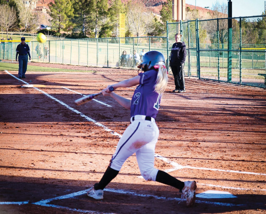 Sydney White, LHS pitcher, swings for the fence. Photo credit: Riley Livingston