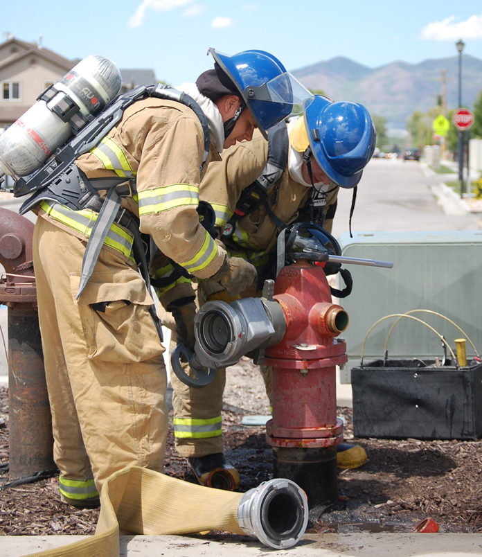 Lehi City Fire Department Interns Zack Erickson (front) and Zac Lucero prepare a fire hydrant for water release as part of their training