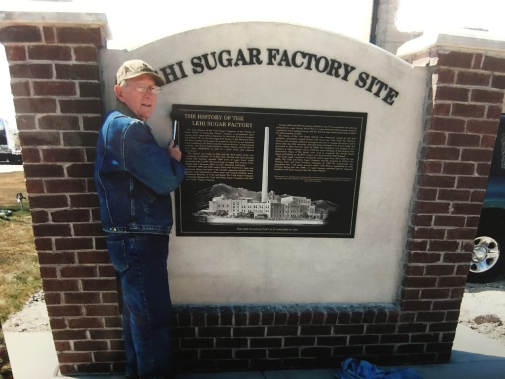 Dee Fowler placing plaque to mark Historic Lehi Sugar Factory site.