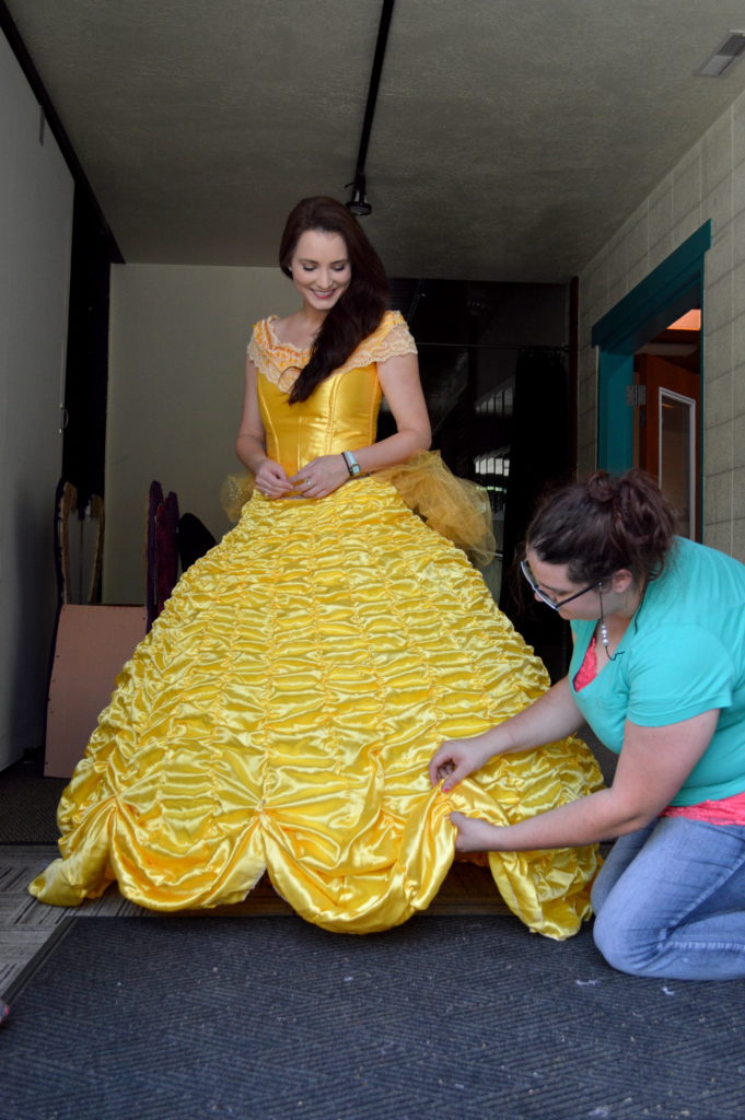 Erica Glenn getting a final fitting for Belle’s ball gown with Mariah Knittle. Photo: Nicole Kunze