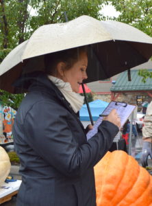 Carrie Fox of the Utah Giant Pumpkin Growers taking down measurements at the weigh-in. Photo: Nicole Kunze