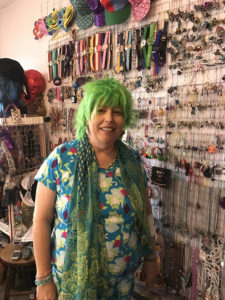 Rebekka Smith in front of her organized jewelry wall. On this day she was looking for frog themed items.